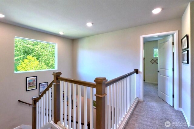 hall featuring recessed lighting, baseboards, an upstairs landing, and carpet