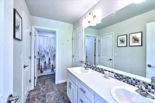 bathroom with double vanity, a sink, toilet, and a shower with curtain