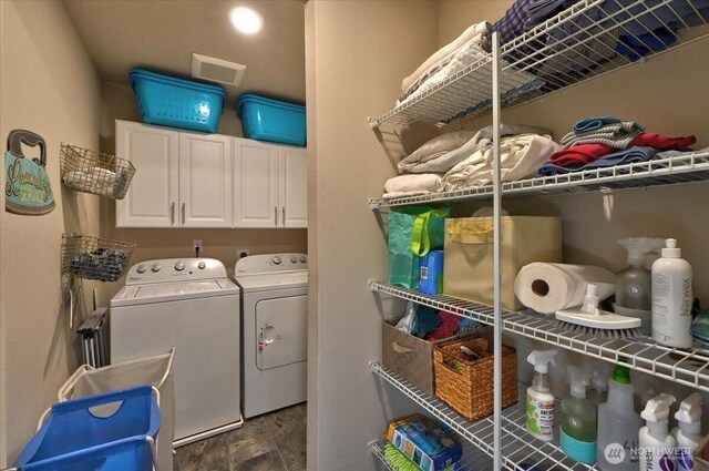 laundry area with visible vents, cabinet space, and washing machine and dryer