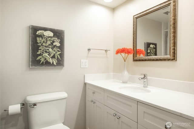 bathroom featuring vanity and toilet