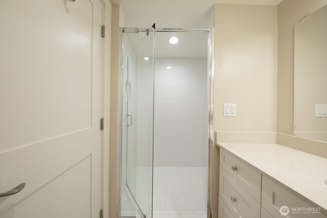 bathroom featuring recessed lighting, a shower stall, and vanity