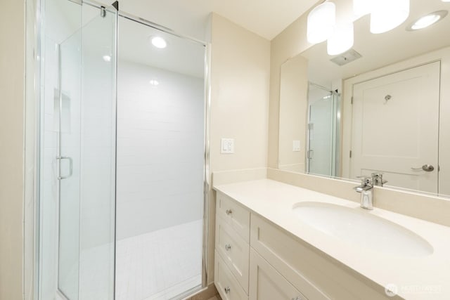 full bathroom featuring recessed lighting, a shower stall, and vanity