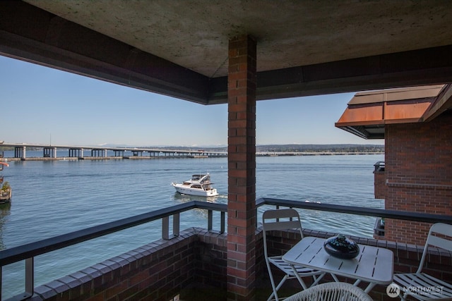 view of dock featuring a water view and a balcony