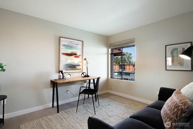 office area featuring baseboards and wood finished floors