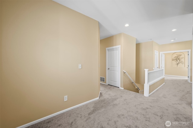 carpeted empty room featuring recessed lighting, baseboards, and visible vents
