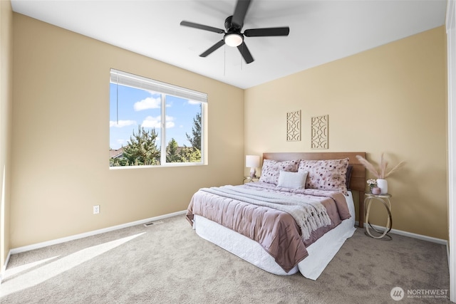 carpeted bedroom with a ceiling fan, baseboards, and visible vents