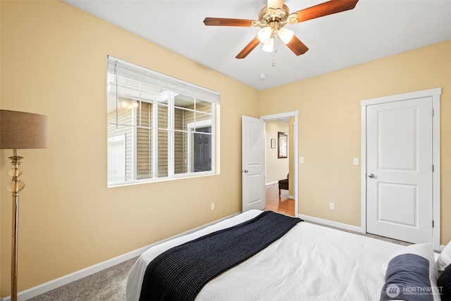 bedroom featuring baseboards, a ceiling fan, and carpet flooring