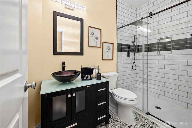 full bathroom with vanity, a shower stall, and toilet