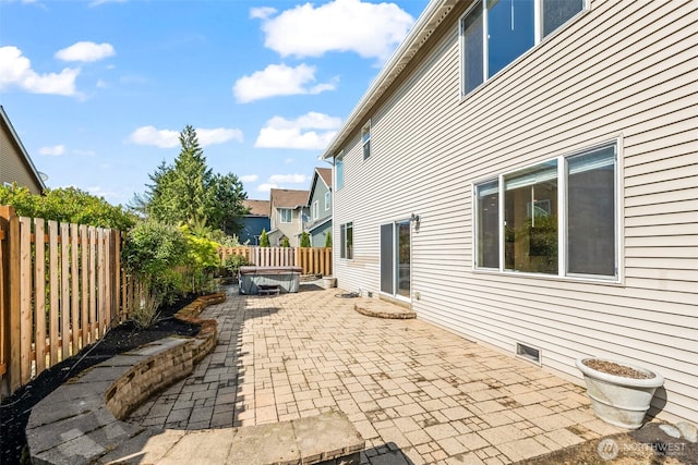 view of patio featuring a fenced backyard and a hot tub