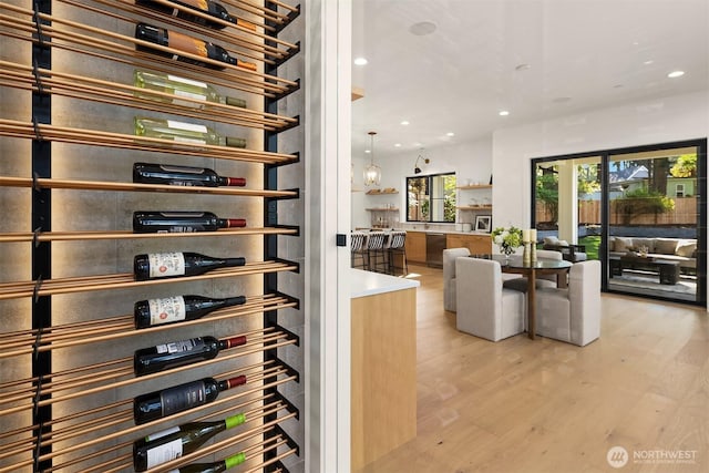 wine cellar with recessed lighting and light wood-style floors