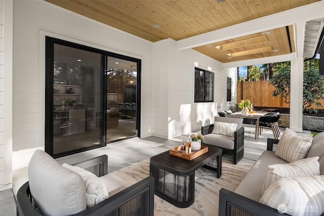 view of patio with fence, an outdoor hangout area, and outdoor dining space