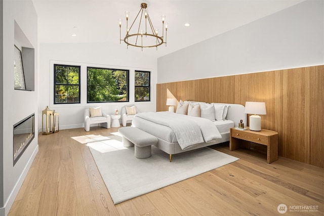 bedroom featuring wood finished floors and a chandelier