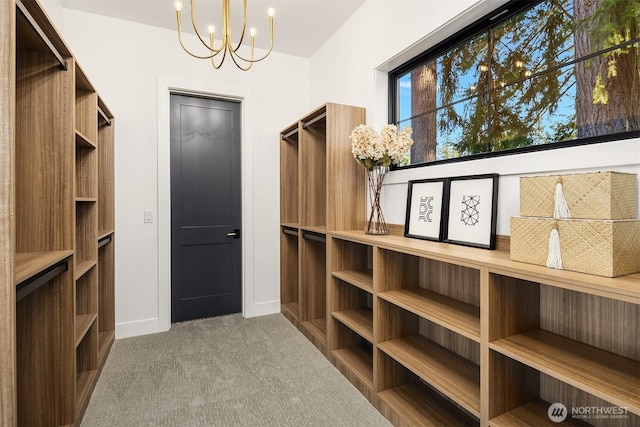 spacious closet with carpet flooring and a notable chandelier