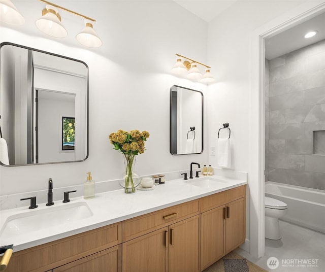 bathroom with a sink, tile patterned flooring, toilet, and double vanity