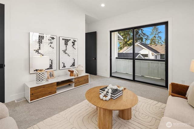 living area with recessed lighting, baseboards, and carpet