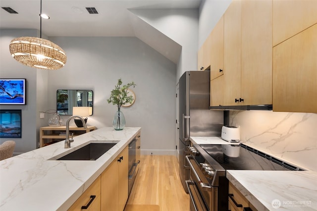 kitchen with a sink, light brown cabinetry, visible vents, and stainless steel range with electric stovetop