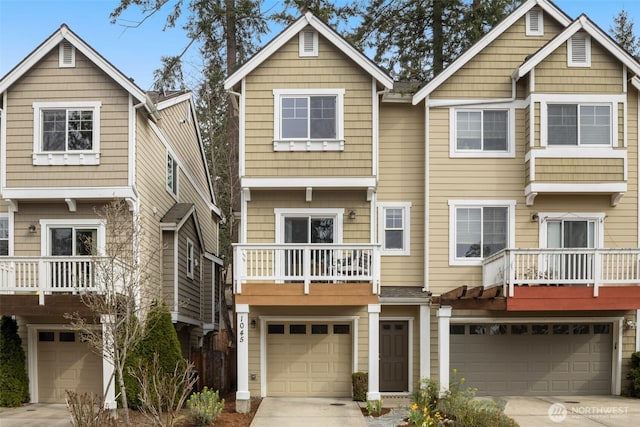 view of front of home with an attached garage, a balcony, and driveway