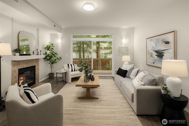 living room featuring wood finished floors, a wealth of natural light, and a fireplace