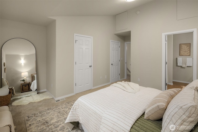 bedroom featuring visible vents, baseboards, high vaulted ceiling, and light carpet