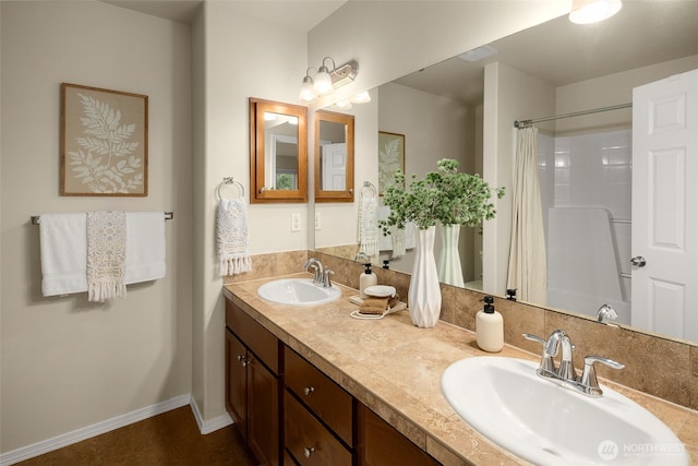 full bathroom with a sink, double vanity, and a shower with shower curtain
