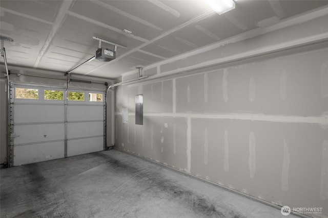 garage with a garage door opener and electric panel