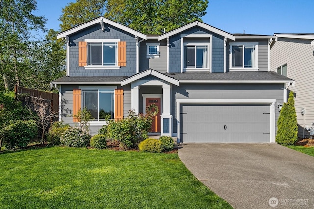 12011 SE 299th Pl, Auburn, WA 98092 - view of front of home with fence, a front yard, a shingled roof, an attached garage, and driveway