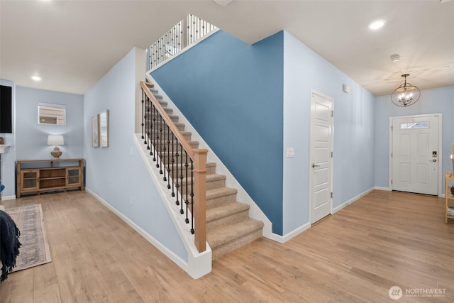 12011 SE 299th Pl, Auburn, WA 98092 - foyer entrance featuring an inviting chandelier, baseboards, wood finished floors, and stairway