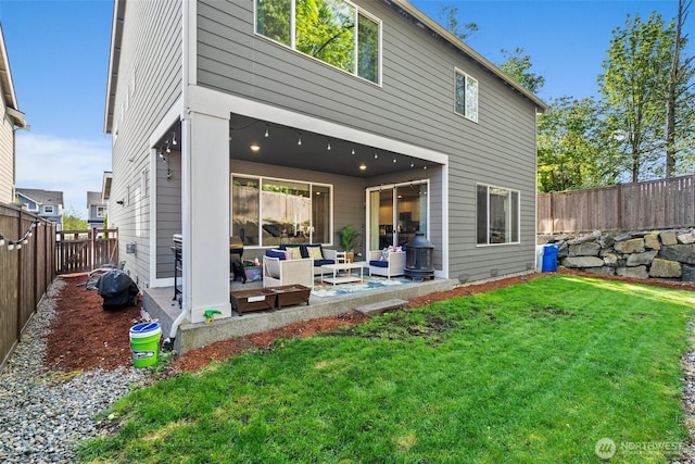 12011 SE 299th Pl, Auburn, WA 98092 - back of property featuring a lawn, a fenced backyard, an outdoor hangout area, and a patio