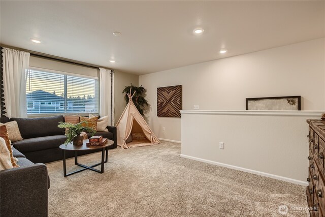 living room featuring baseboards, recessed lighting, and light colored carpet