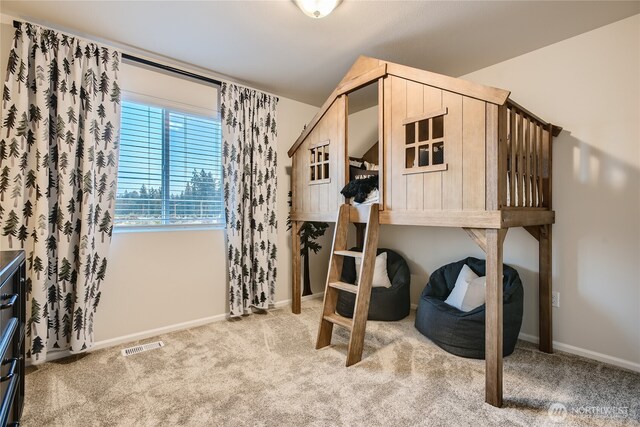 carpeted bedroom with baseboards and visible vents