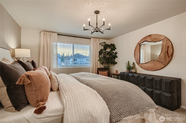 carpeted bedroom featuring a notable chandelier