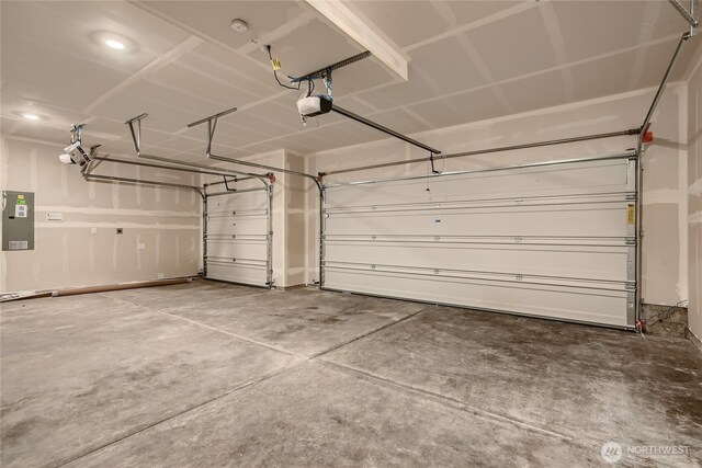 garage featuring a garage door opener and electric panel