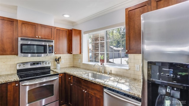 25025 SE Klahanie Blvd Unit L104, Sammamish, WA 98029 - kitchen featuring ornamental molding, tasteful backsplash, light stone counters, a sink, and appliances with stainless steel finishes