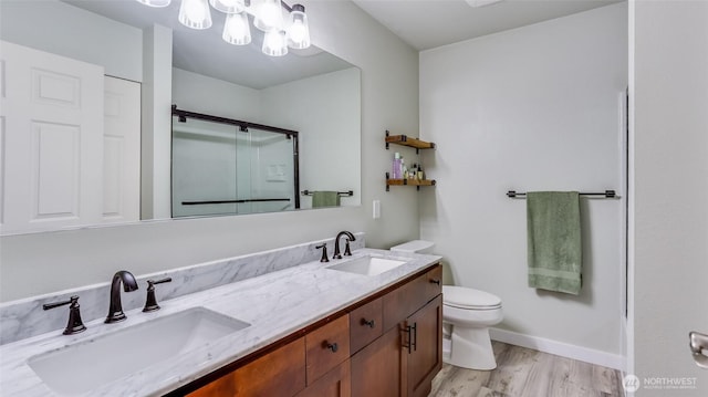 25025 SE Klahanie Blvd Unit L104, Sammamish, WA 98029 - bathroom featuring wood finished floors, toilet, a sink, and a stall shower