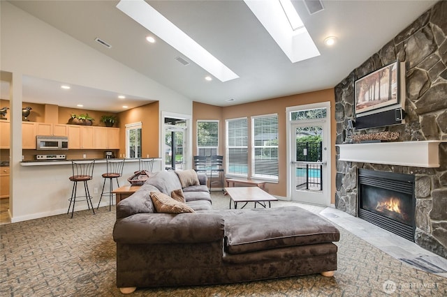 25025 SE Klahanie Blvd Unit L104, Sammamish, WA 98029 - carpeted living area with visible vents, recessed lighting, vaulted ceiling with skylight, and a wealth of natural light