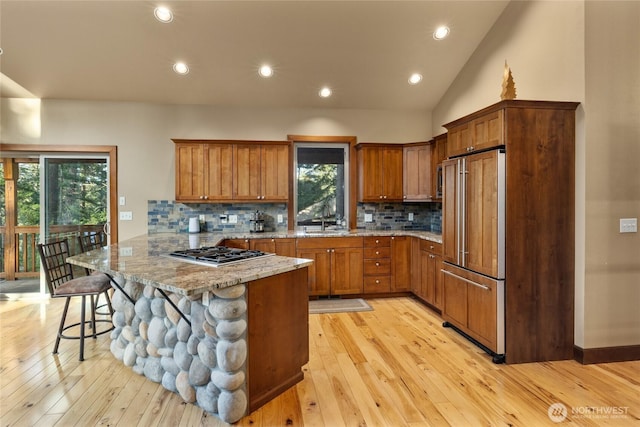 1570 Skull Springs Rd, Cle Elum, WA 98922 - kitchen featuring paneled refrigerator, stainless steel gas cooktop, a peninsula, a sink, and brown cabinetry