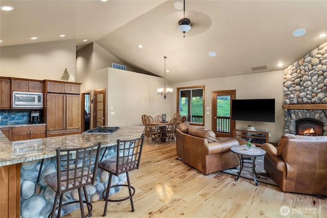 1570 Skull Springs Rd, Cle Elum, WA 98922 - living room featuring light wood finished floors, a chandelier, high vaulted ceiling, recessed lighting, and a fireplace