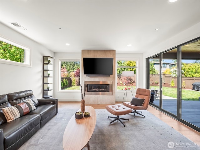 6588 Serenity Loop, Gig Harbor, WA 98335 - living room with wood finished floors, a fireplace, healthy amount of natural light, and recessed lighting