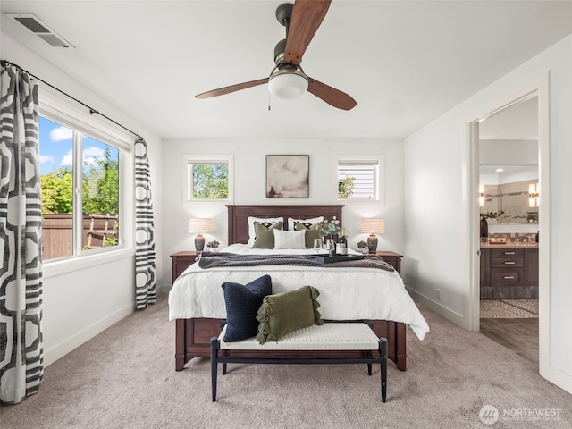6588 Serenity Loop, Gig Harbor, WA 98335 - bedroom with multiple windows, baseboards, light carpet, and connected bathroom
