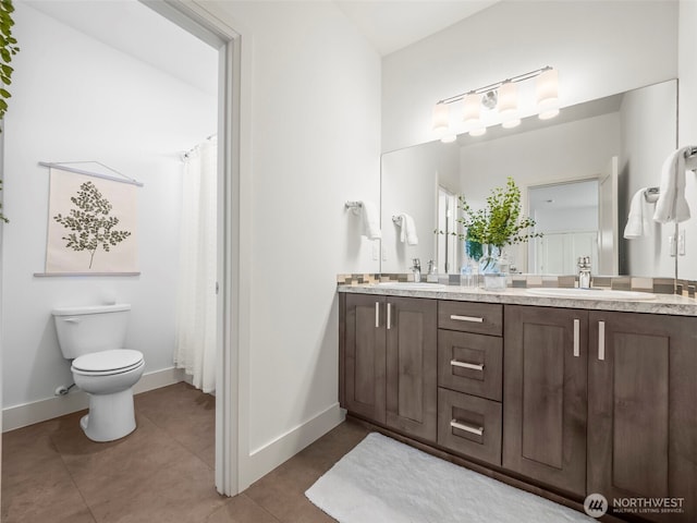 6588 Serenity Loop, Gig Harbor, WA 98335 - bathroom with double vanity, baseboards, toilet, and tile patterned floors