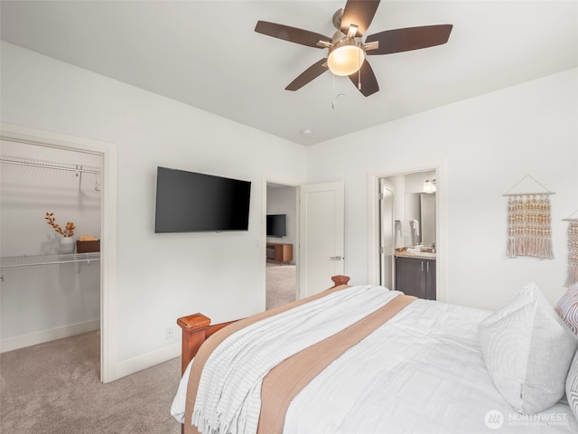 6588 Serenity Loop, Gig Harbor, WA 98335 - bedroom featuring light colored carpet, a spacious closet, baseboards, ceiling fan, and connected bathroom
