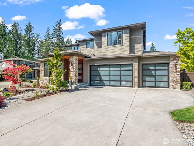 6588 Serenity Loop, Gig Harbor, WA 98335 - view of front of house featuring stone siding, an attached garage, and driveway