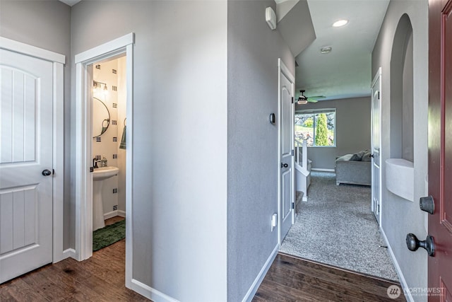 corridor featuring recessed lighting, baseboards, and dark wood-style flooring