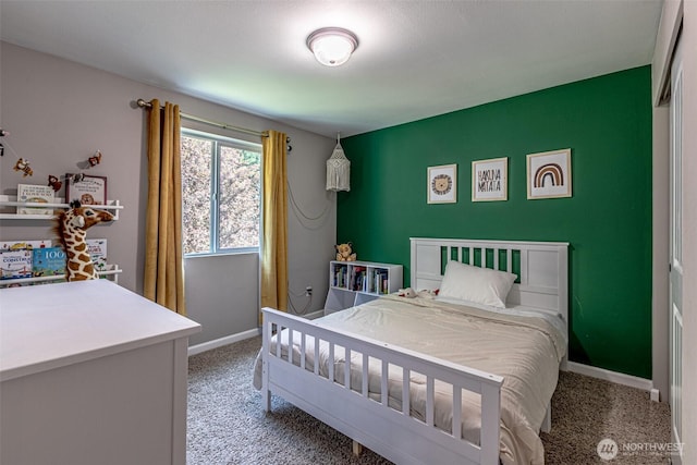 bedroom featuring baseboards and light carpet