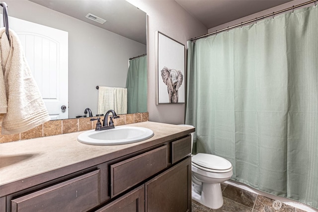 bathroom with vanity, toilet, stone finish floor, curtained shower, and visible vents
