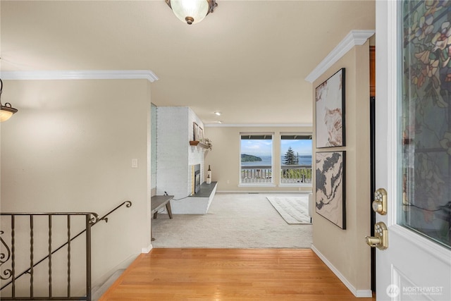 1319 Madrona Way NW, Gig Harbor, WA 98332 - hallway featuring baseboards, ornamental molding, an upstairs landing, and light wood-style floors