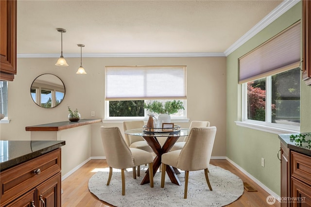 1319 Madrona Way NW, Gig Harbor, WA 98332 - dining area featuring light wood finished floors, ornamental molding, baseboards, and visible vents