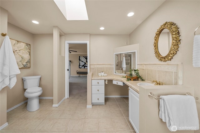 1319 Madrona Way NW, Gig Harbor, WA 98332 - full bathroom with a skylight, toilet, vanity, recessed lighting, and tile patterned flooring