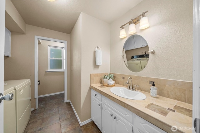 1319 Madrona Way NW, Gig Harbor, WA 98332 - bathroom featuring vanity, baseboards, independent washer and dryer, and tasteful backsplash