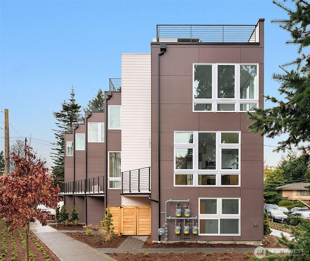 rear view of house featuring stucco siding